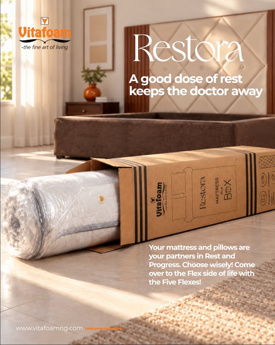 Vitafoam Restora mattress in a box, with the rolled mattress beside its packaging in a bedroom